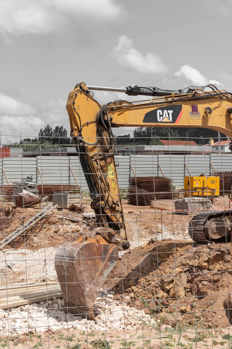 Yellow excavator working at a construction site; representative stock photograph
